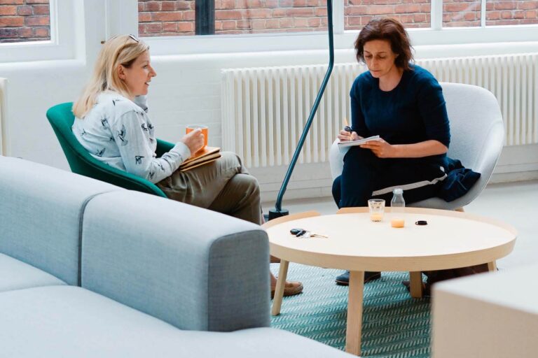 Zwei Frauen, die eine ist eine Führungskraft und coacht die andere.